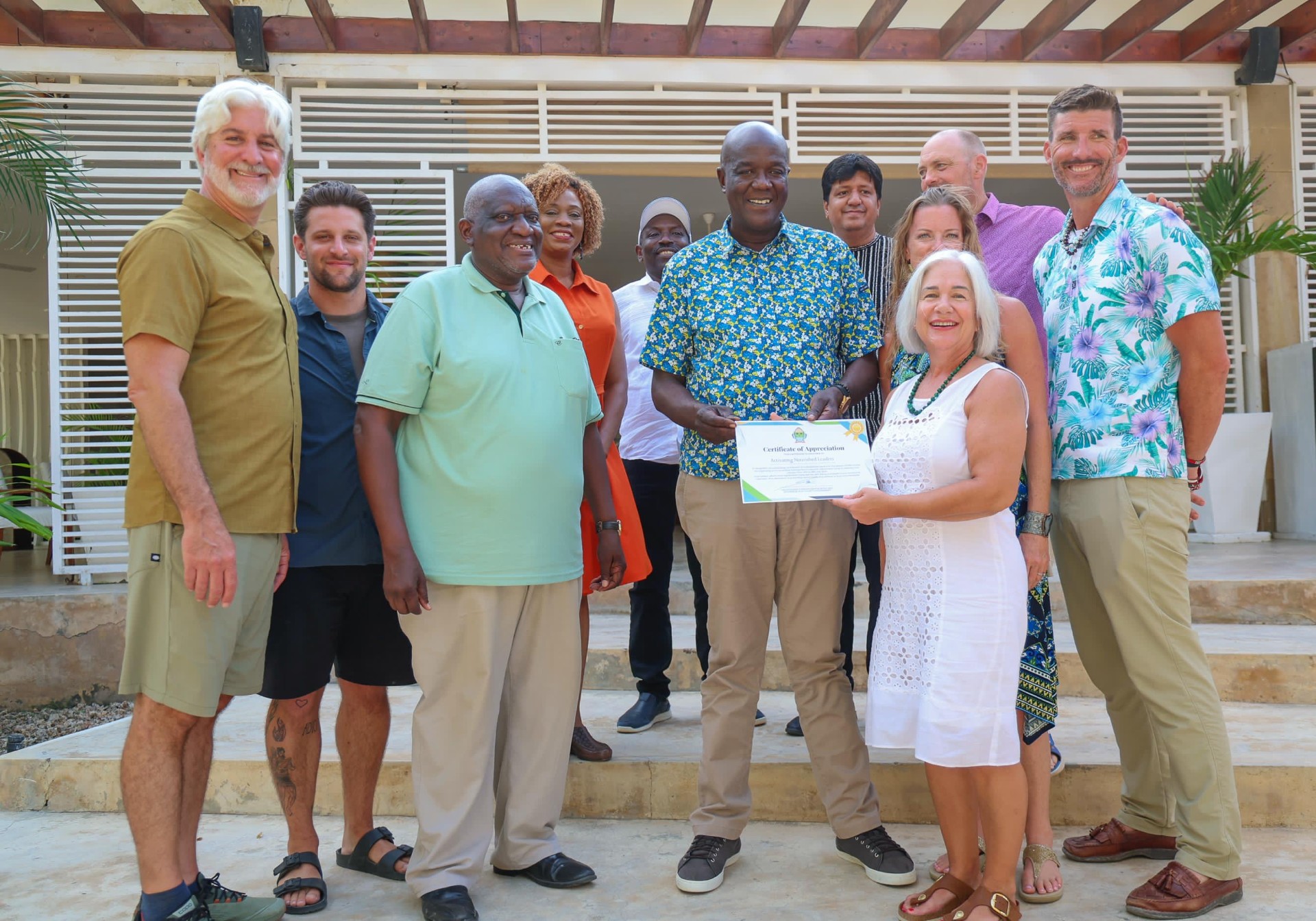 Team of volunteer practitioners standing with Kenyan partners